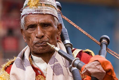 "Blowing a bag pipe at shivaratri" Varanasi, Uttar Pradesh
